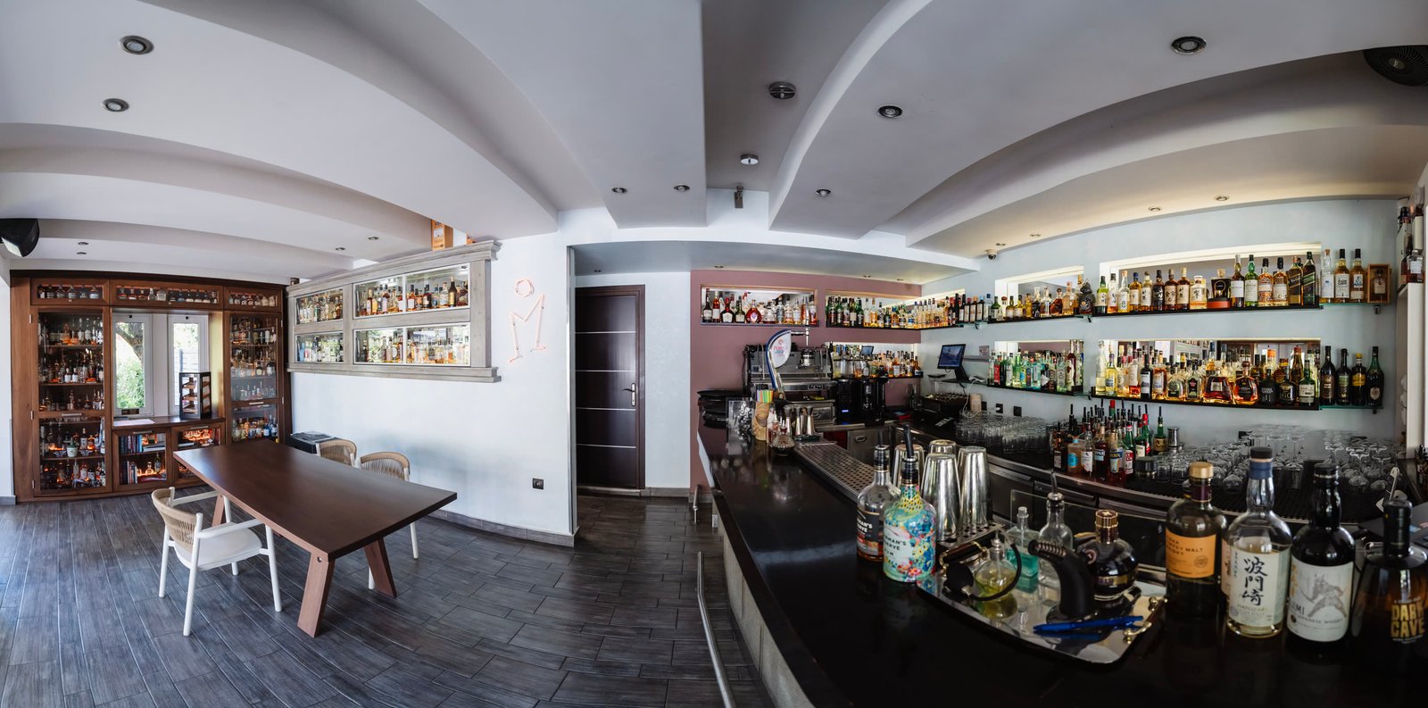 The Madison bar room in one sweep — the tasting table, the spirits library and the long counter
