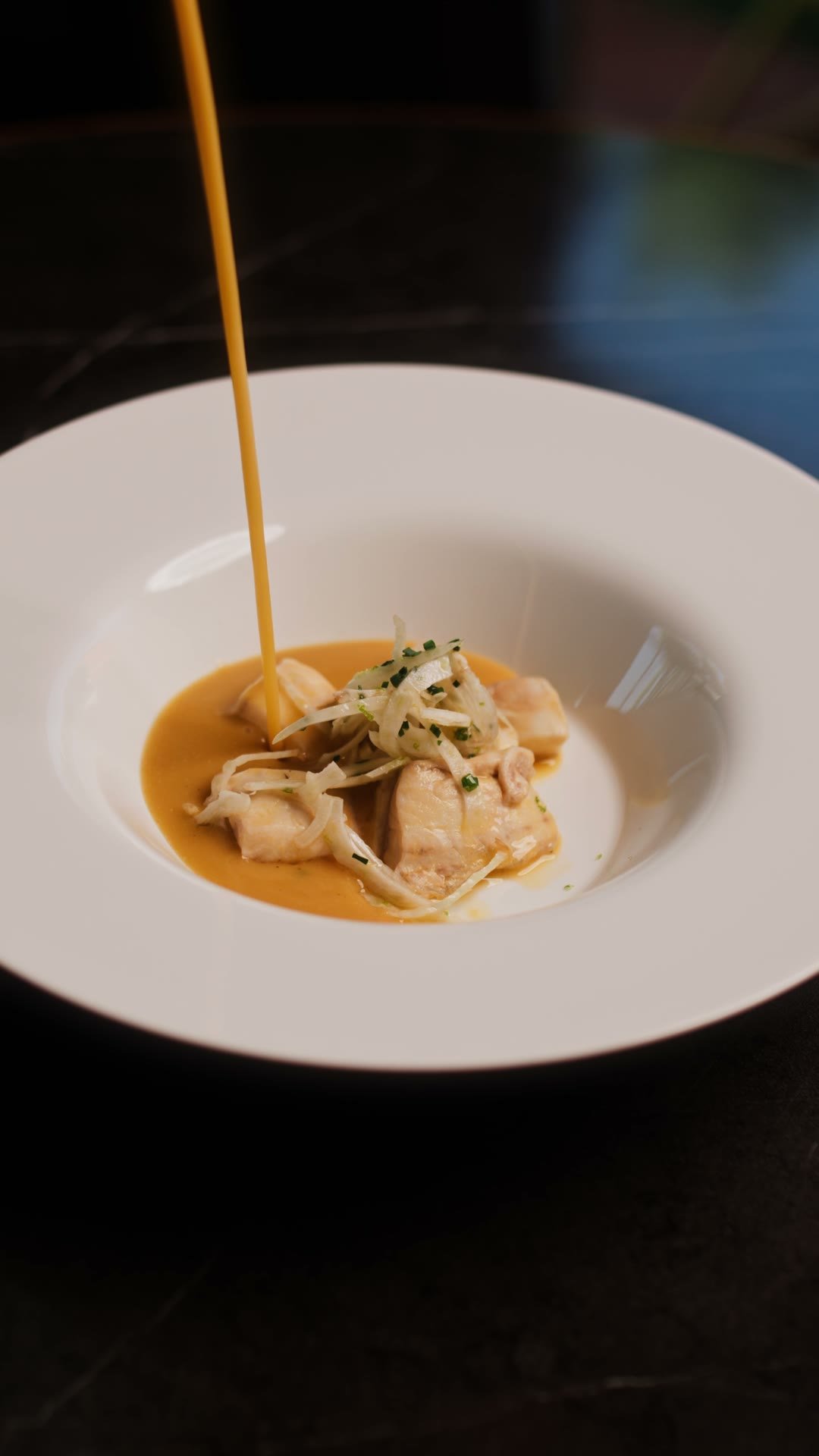 Shellfish bisque poured over gnocchi at the Madison pass